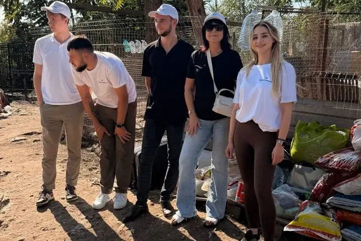 Alliance Manpower colleagues at an animal shelter, standing beside the pet food they brought