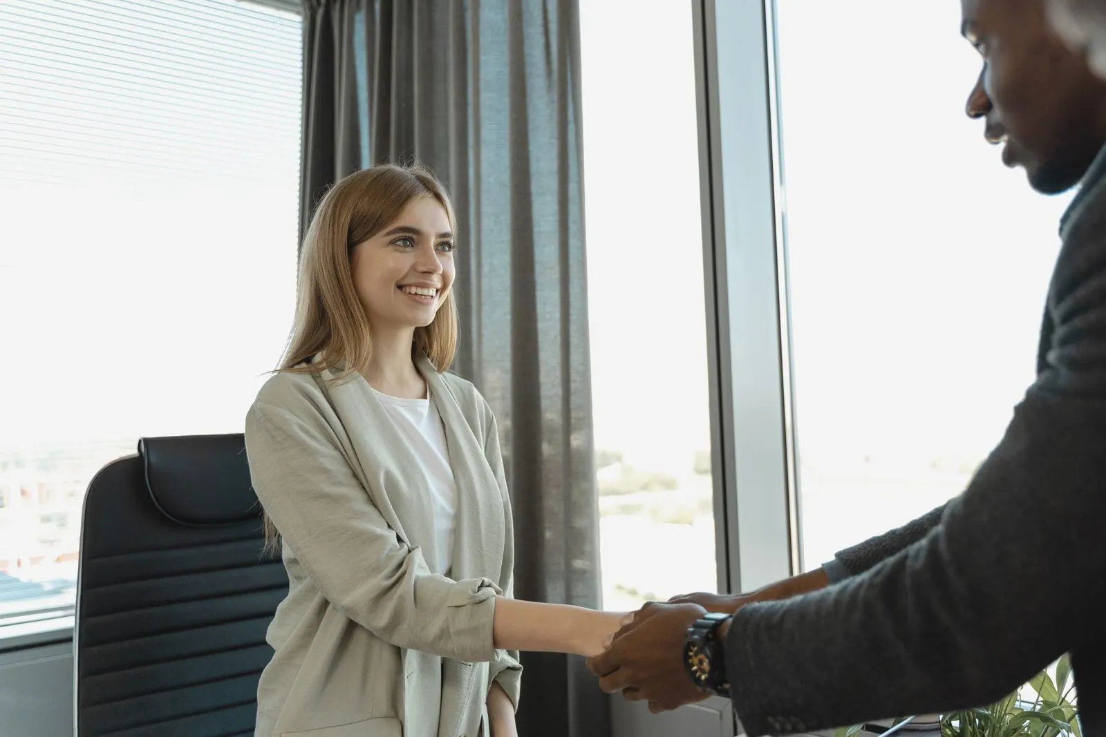 Candidate smiling during a successful job interview handshake